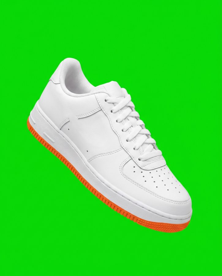 White sneaker on a green backdrop